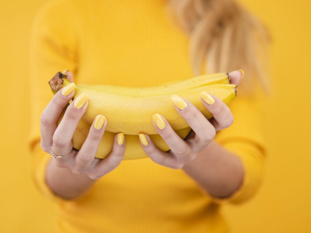 close up woman holding bananas